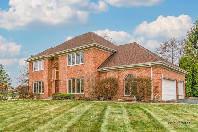 view of front of home featuring a front yard and a garage