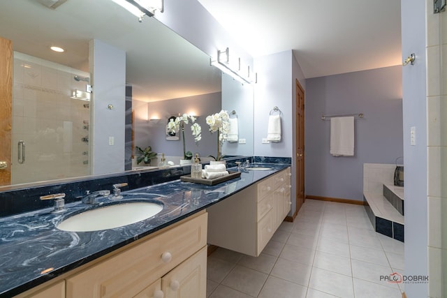 bathroom with tile patterned floors, vanity, and a shower with door