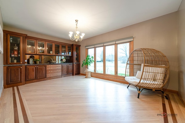 sitting room featuring light hardwood / wood-style floors and an inviting chandelier