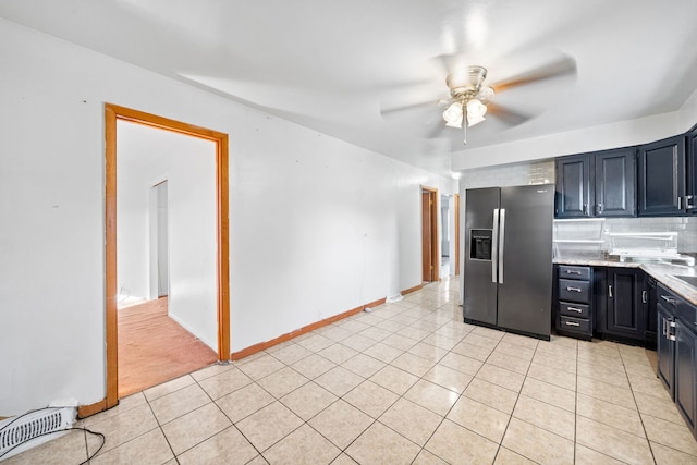 kitchen featuring backsplash, ceiling fan, light tile patterned floors, and stainless steel refrigerator with ice dispenser