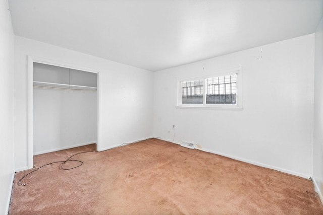 unfurnished bedroom with a closet and carpet floors