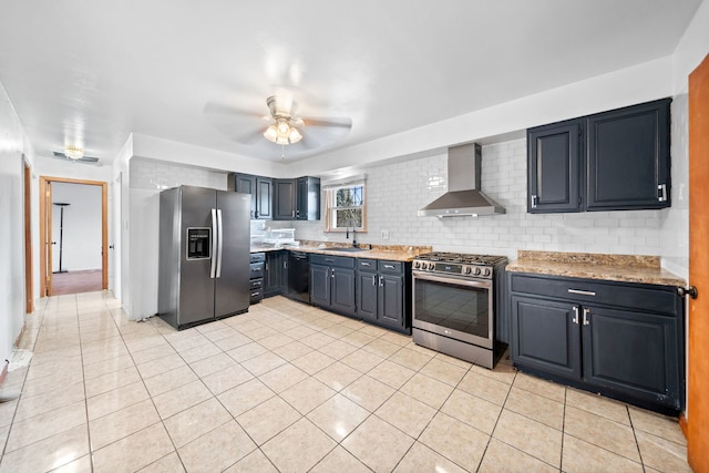 kitchen featuring appliances with stainless steel finishes, wall chimney exhaust hood, ceiling fan, sink, and light tile patterned flooring