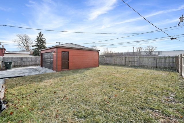 view of yard with a patio area, an outbuilding, and a garage