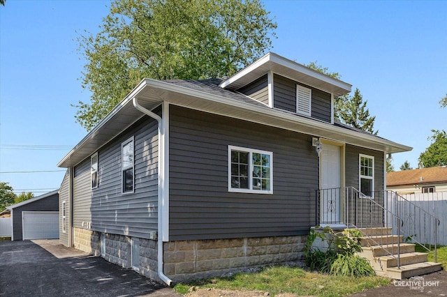 view of front of home with an outdoor structure and a garage