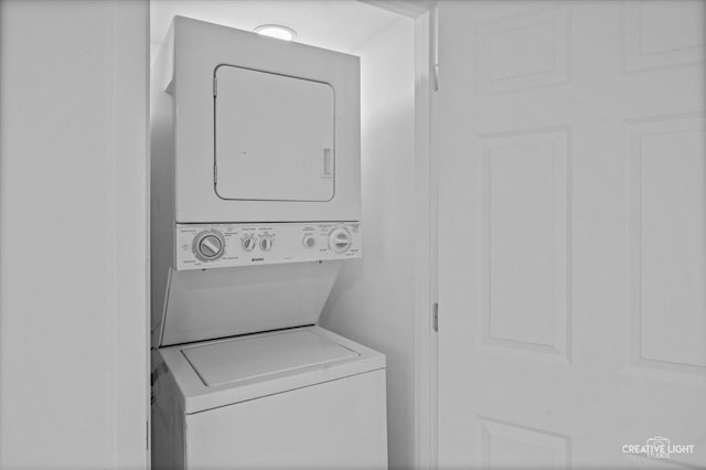 laundry area with stacked washer / drying machine