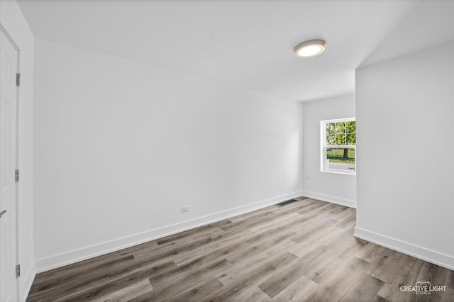 unfurnished room with hardwood / wood-style floors