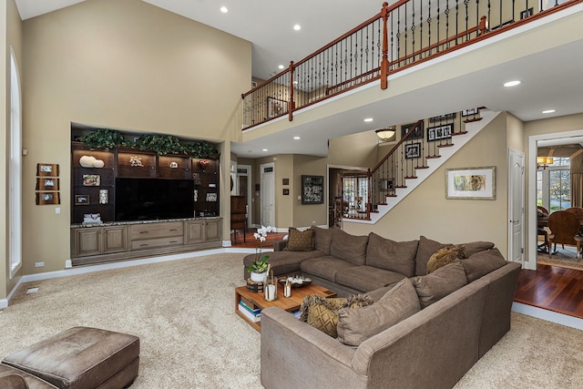 living room with carpet flooring and a high ceiling