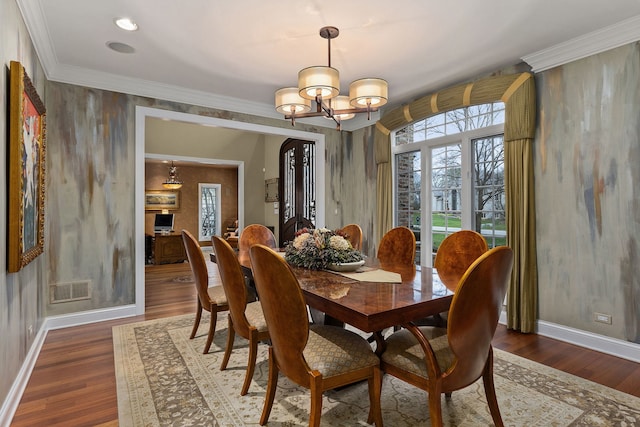 dining space featuring crown molding, an inviting chandelier, and dark hardwood / wood-style flooring