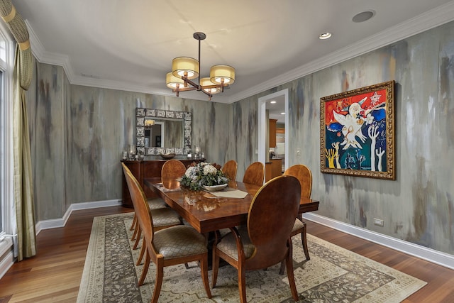 dining space featuring ornamental molding, a chandelier, and wood-type flooring