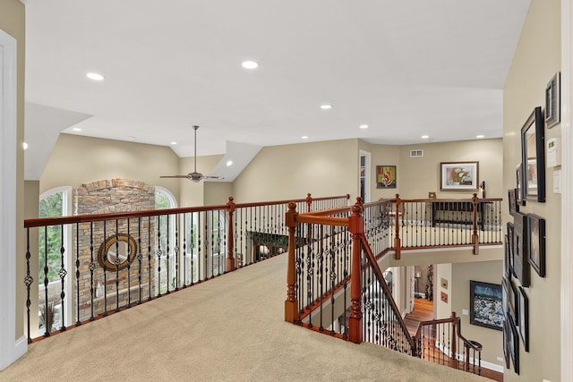 hallway with lofted ceiling and carpet floors