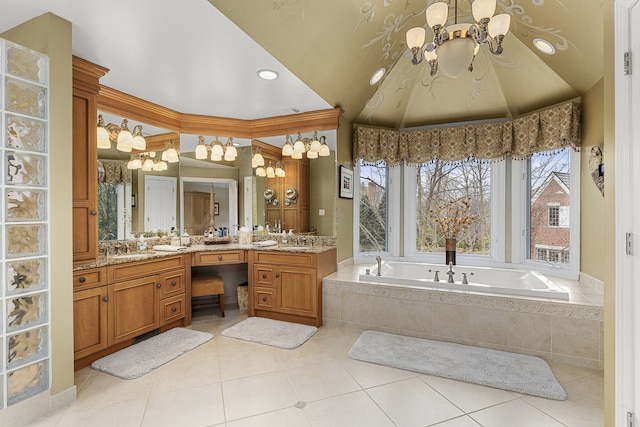 bathroom featuring vanity, tiled bath, a chandelier, and tile patterned flooring