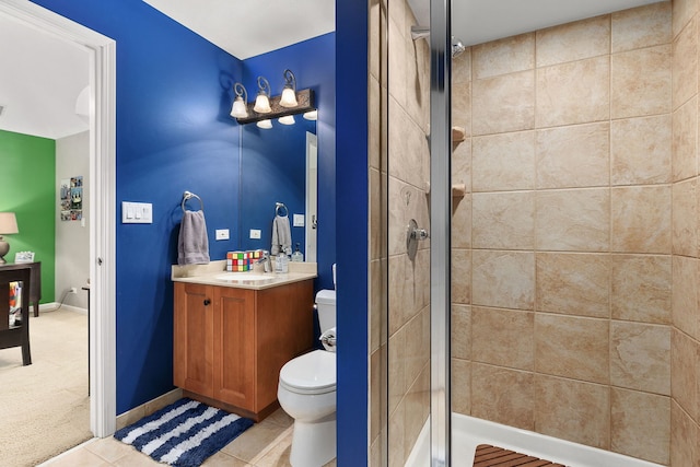 bathroom featuring vanity, toilet, a shower with shower door, and tile patterned flooring