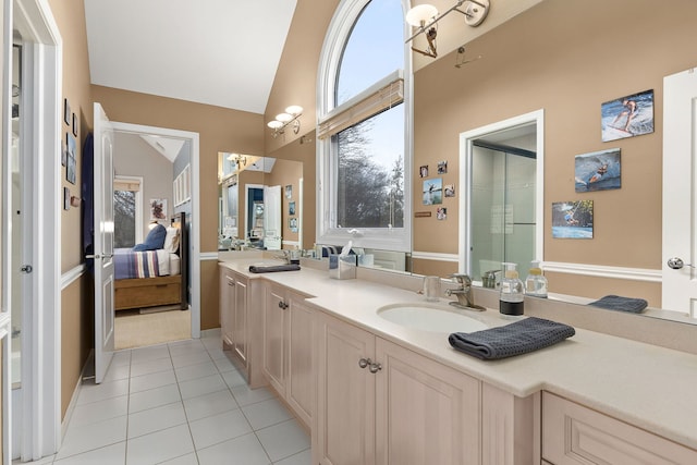 bathroom featuring vanity, high vaulted ceiling, and tile patterned floors