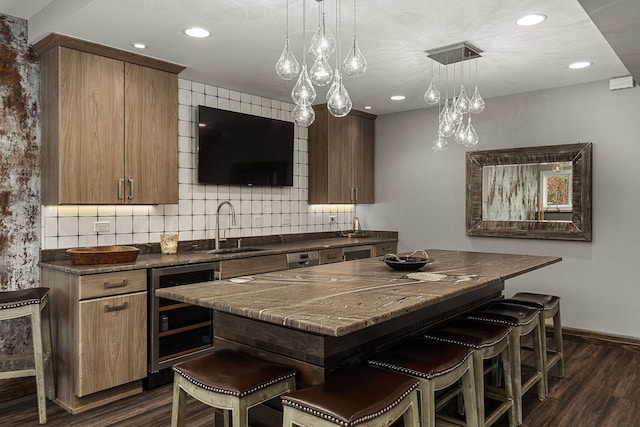 kitchen featuring sink, a breakfast bar, wine cooler, dark hardwood / wood-style flooring, and decorative backsplash