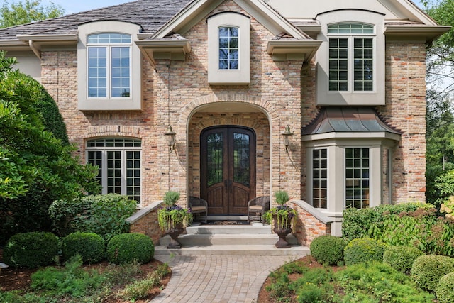 view of exterior entry featuring french doors