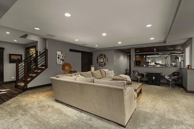 living room with a barn door and bar area