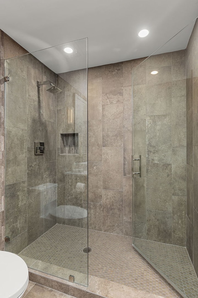 bathroom featuring a shower with shower door