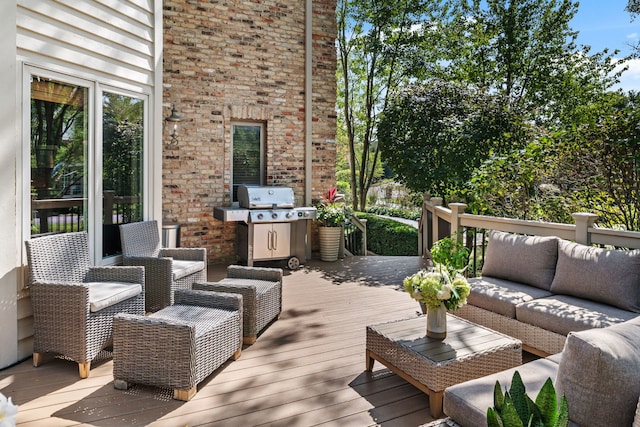 wooden deck featuring an outdoor living space and area for grilling