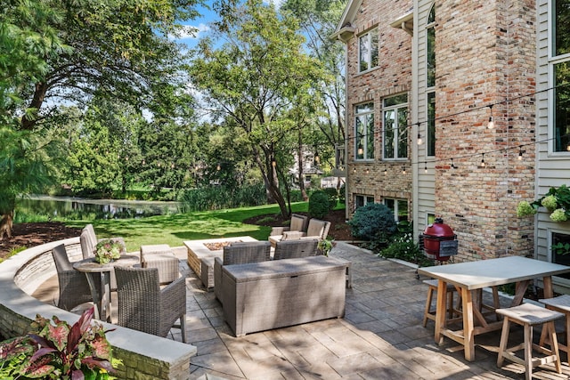 view of patio / terrace featuring a water view and outdoor lounge area