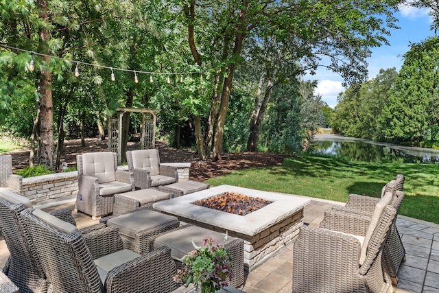 view of patio / terrace featuring a water view and an outdoor living space with a fire pit