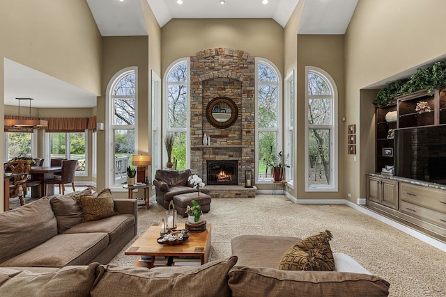 carpeted living room featuring a fireplace and high vaulted ceiling