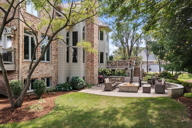 view of yard with a patio area and an outdoor living space with a fire pit