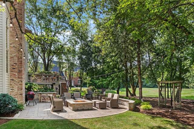 view of yard with a patio and an outdoor living space with a fire pit