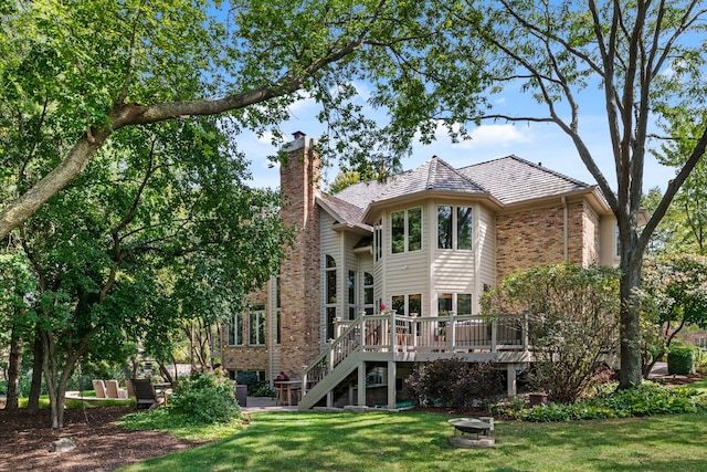 back of house with a wooden deck and a yard