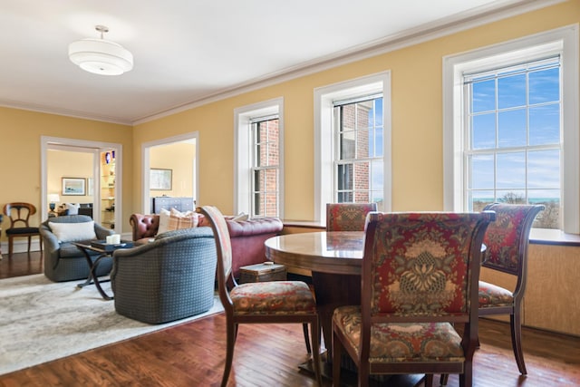 dining area featuring hardwood / wood-style floors and crown molding