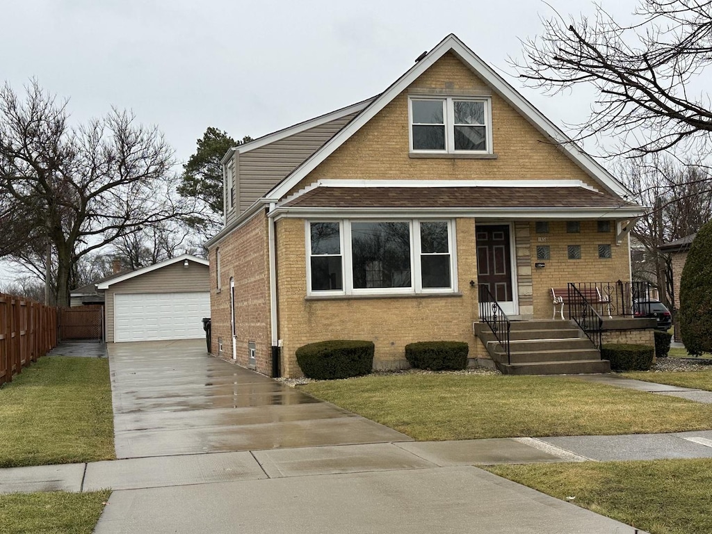 view of front of house featuring an outbuilding, a garage, and a front yard