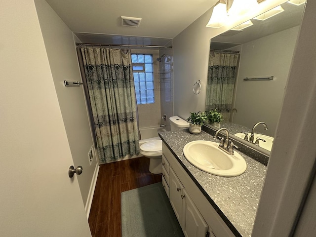 full bathroom with hardwood / wood-style floors, vanity, toilet, and shower / bathtub combination with curtain