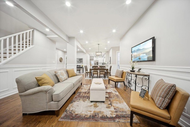 living room featuring a chandelier and wood-type flooring