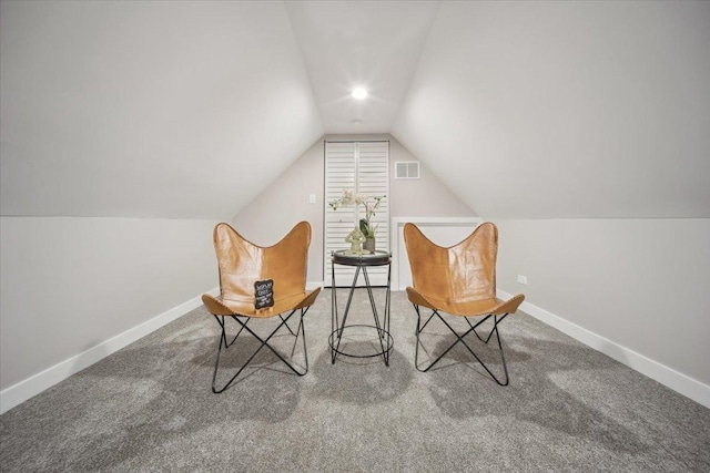 unfurnished room featuring carpet floors and lofted ceiling