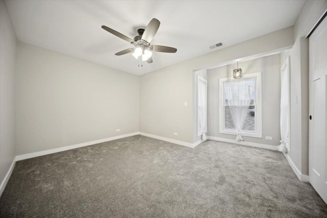 carpeted empty room with ceiling fan