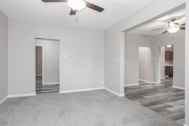 carpeted empty room featuring ceiling fan