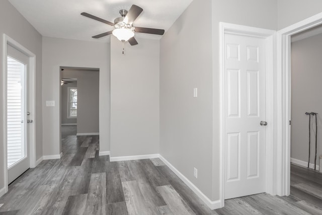 unfurnished room with dark hardwood / wood-style floors and ceiling fan