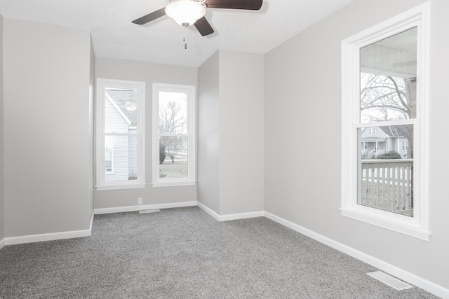 empty room featuring carpet floors and ceiling fan