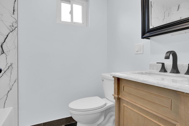 bathroom featuring tile patterned flooring, vanity, and toilet