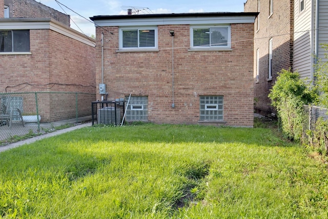 back of property featuring a yard