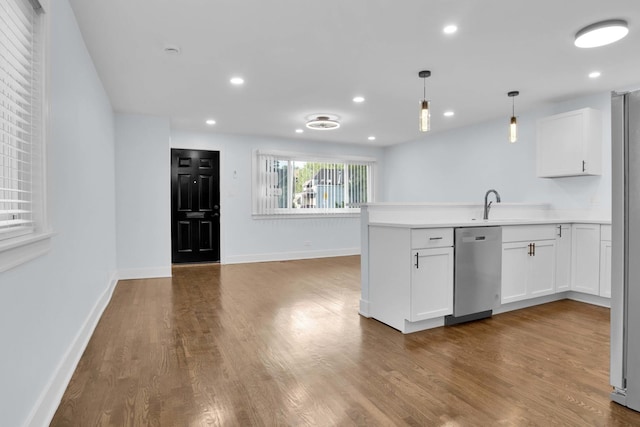 kitchen featuring pendant lighting, dishwasher, sink, light wood-type flooring, and white cabinetry