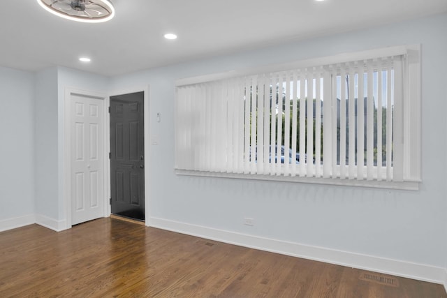 spare room featuring dark hardwood / wood-style floors and a healthy amount of sunlight