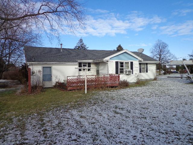 back of house with cooling unit and a deck