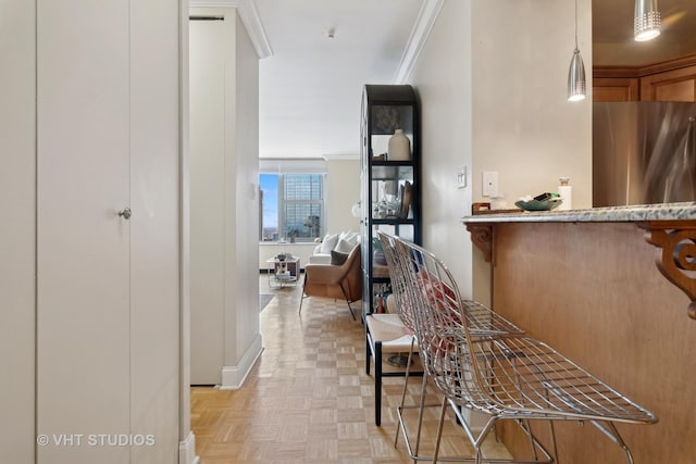 hallway with crown molding and light parquet floors