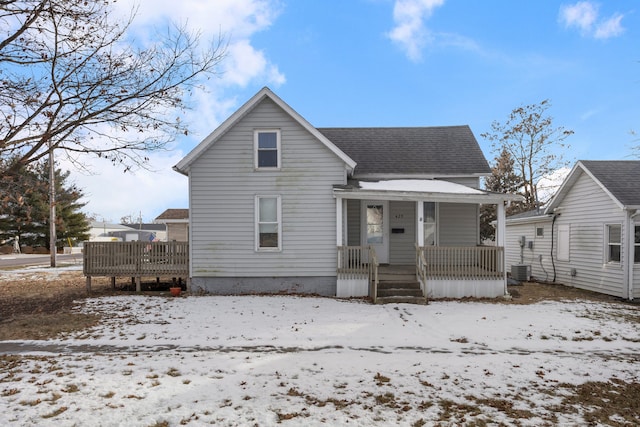 snow covered property featuring a porch