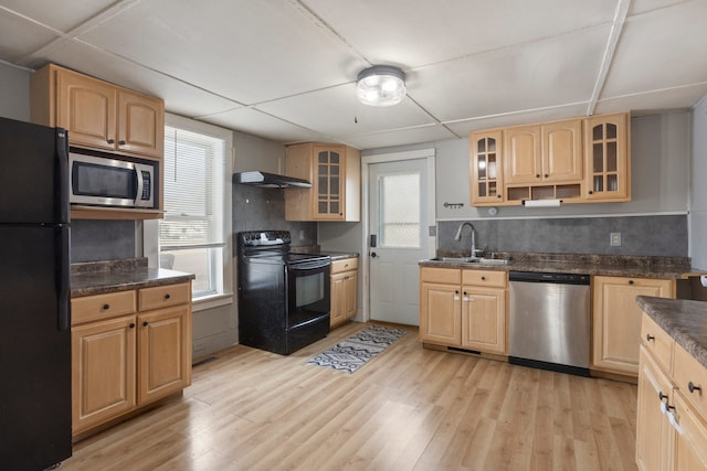 kitchen with light hardwood / wood-style floors, sink, black appliances, and a healthy amount of sunlight