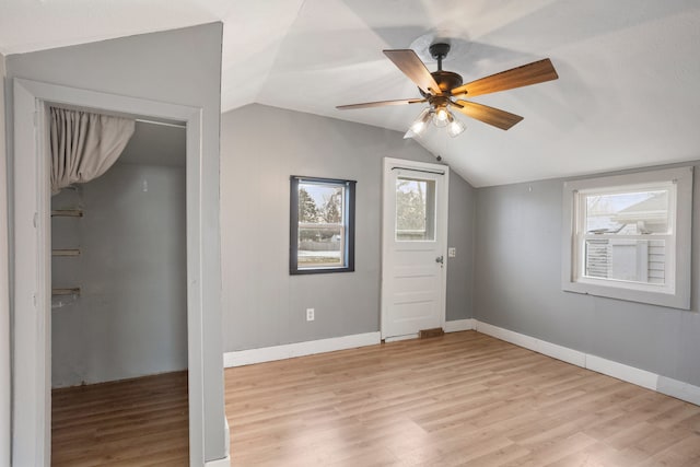 additional living space featuring ceiling fan, lofted ceiling, and light wood-type flooring