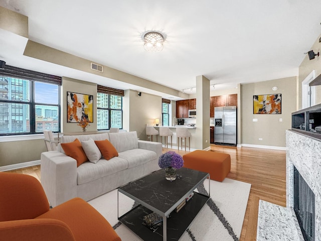 living room with a fireplace and light hardwood / wood-style floors