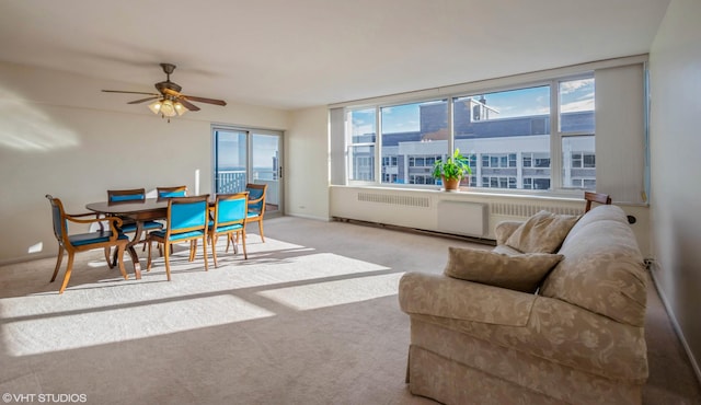 carpeted living room featuring ceiling fan and a wealth of natural light