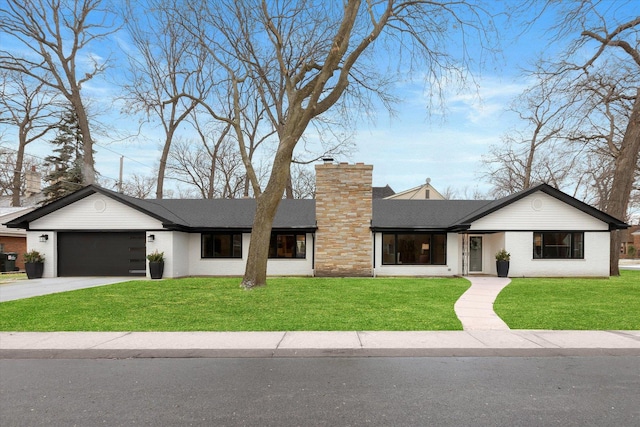 view of front facade featuring a garage and a front lawn