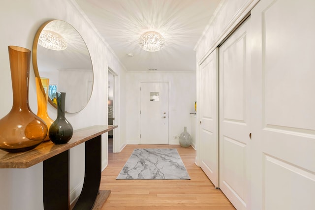 interior space featuring ornamental molding and light hardwood / wood-style flooring